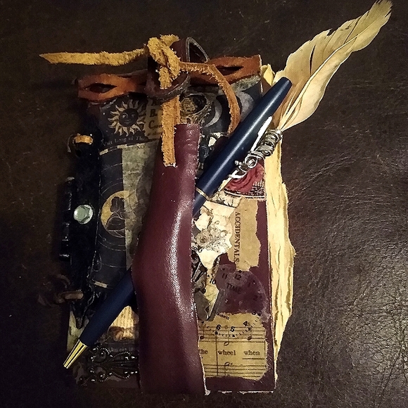 Handmade genuine leather steampunkesque 'junk journal' with feather pen.